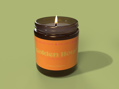 Golden Hour soy wax candle. Which is a citrus mojito scent. Candle jar is amber glass with an orange label across it.